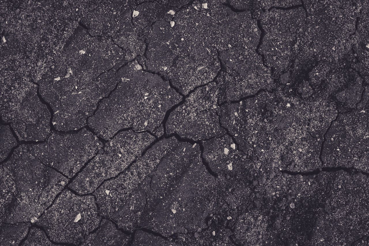 Representative dark pavement texture with cracks and staining