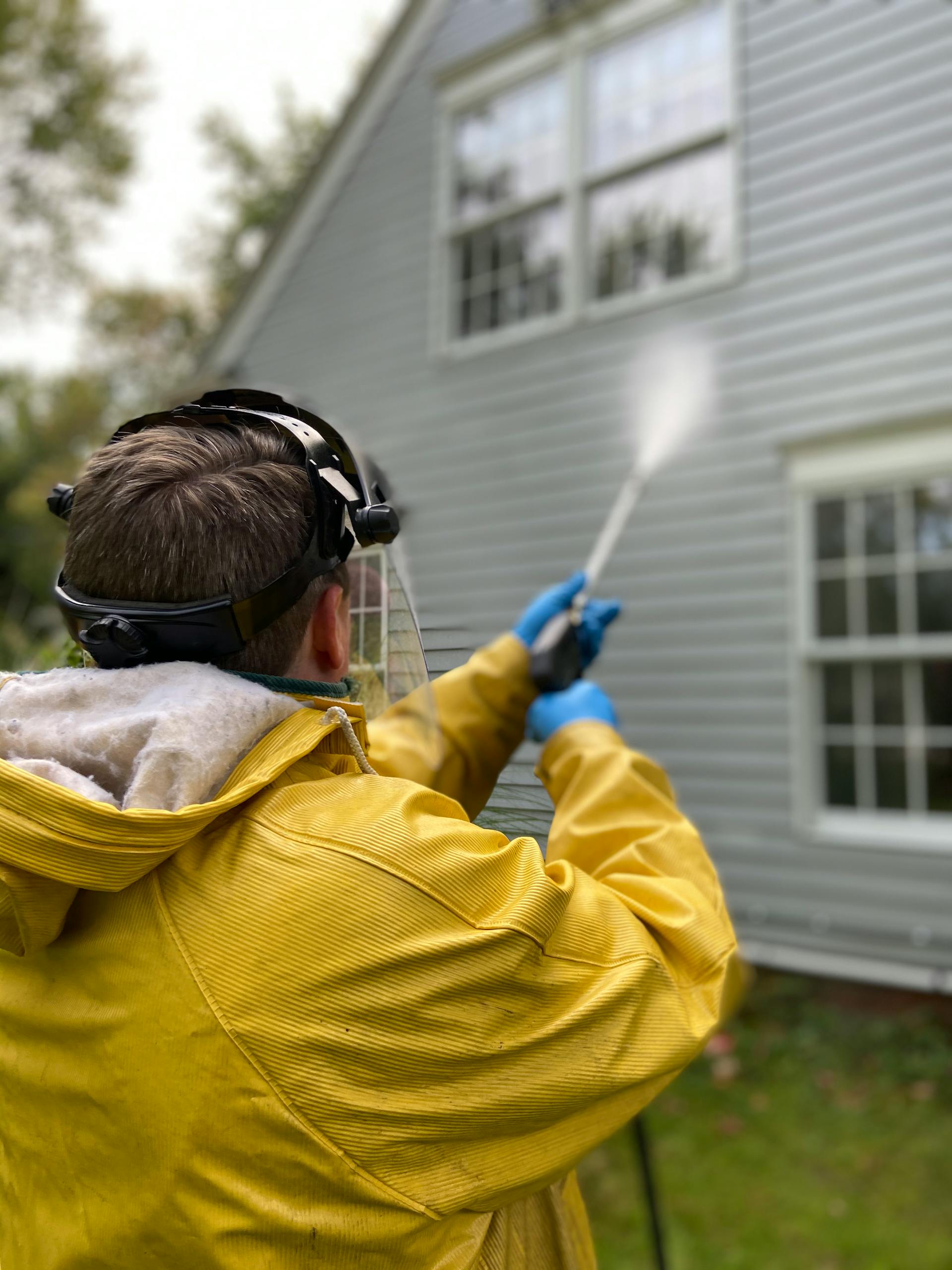 Pressure washing a home exterior surface